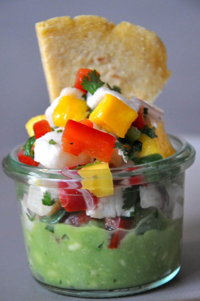 Mini ceviche appetizer with gaucamole at the bottom